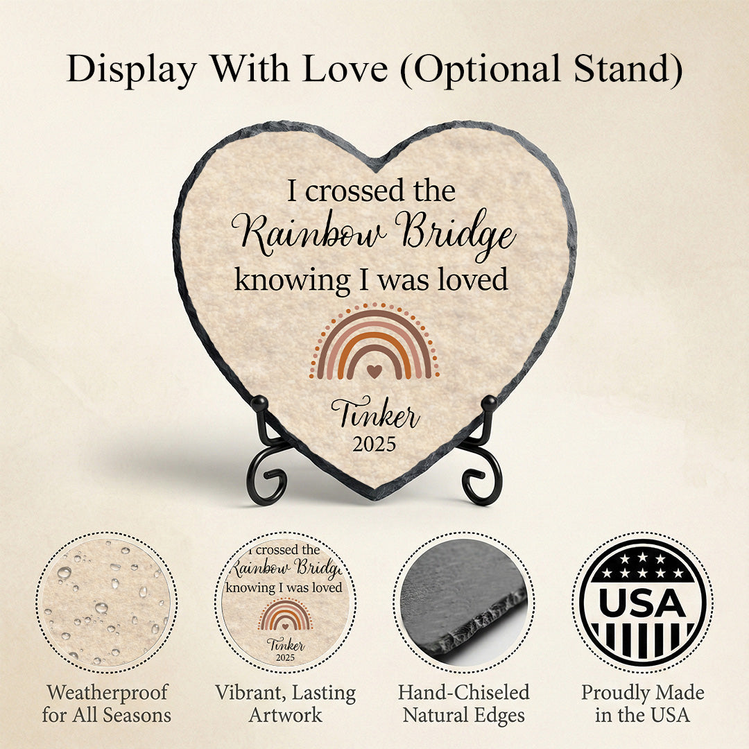 Heart-shaped plaque with engraved text on a stand, featuring a rainbow bridge design.