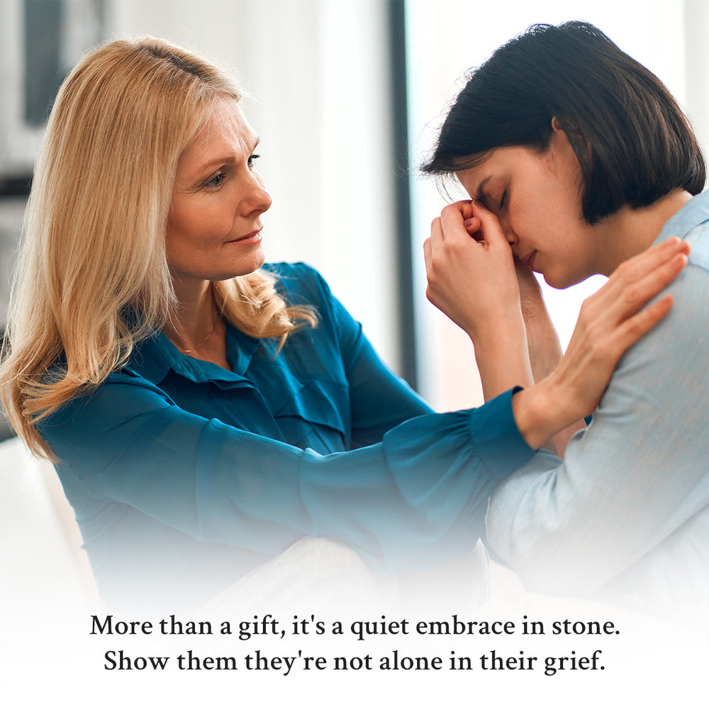 Two women embracing, one comforting the other with a supportive gesture.