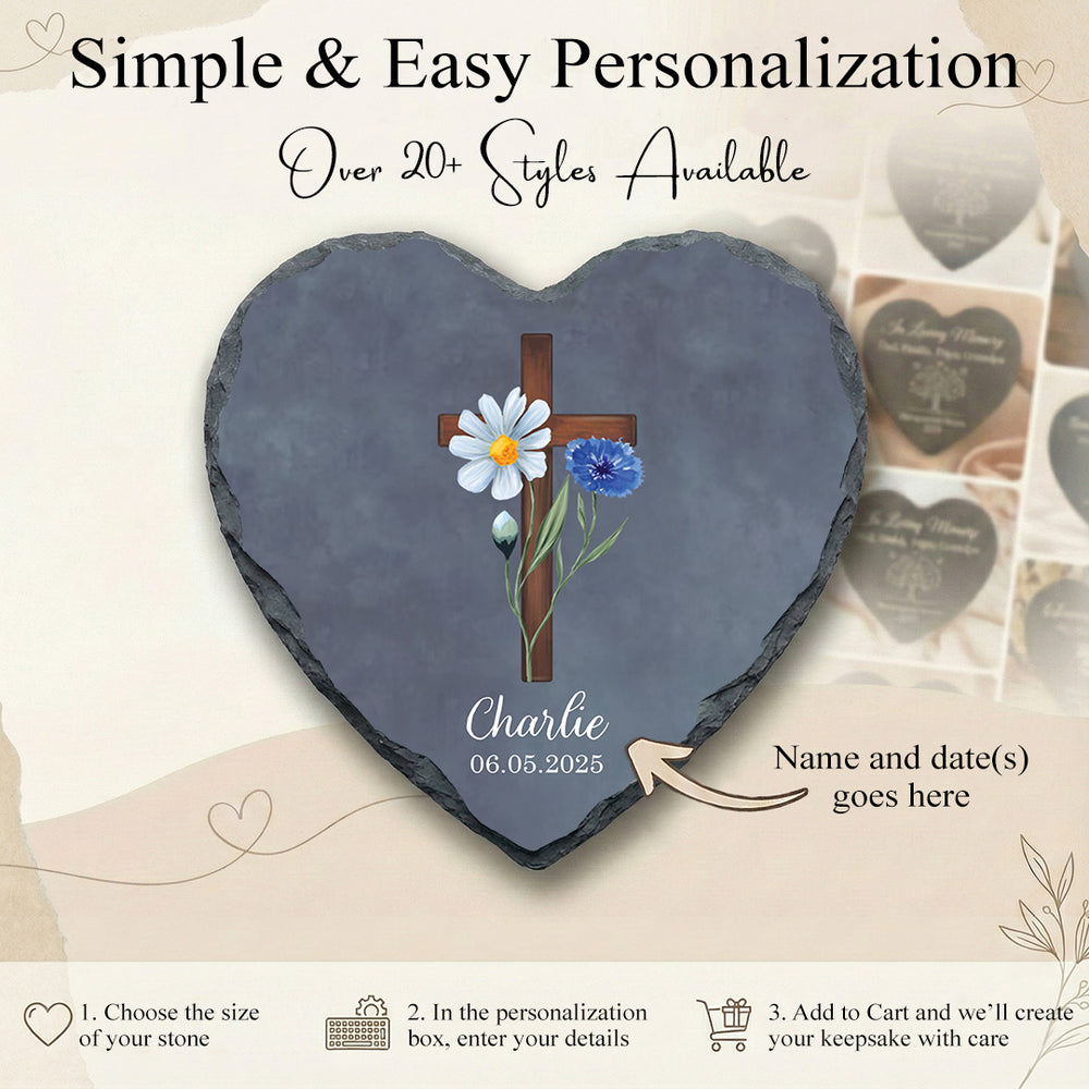 Heart-shaped slate with cross and flowers design, personalized with name and date, on a light background.