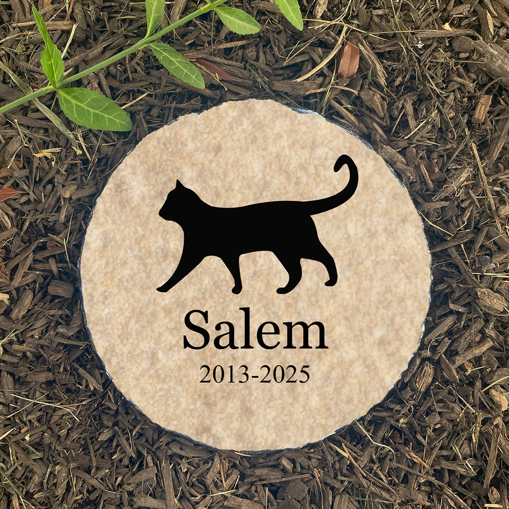 Personalized cat silhouette memorial stone on gravel. Custom-printed with name Salem. Sympathy gift for loss of cat.