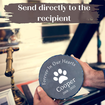 Person holding a pet memorial plaque with 'Forever In Our Hearts Cooper 2008-2025' text.