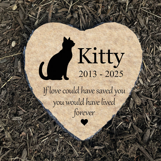 Personalized cat memorial stone on dark mulch. Beige heart with silhouette and quote "If love could have saved you." Cat grave marker. Sympathy gift.