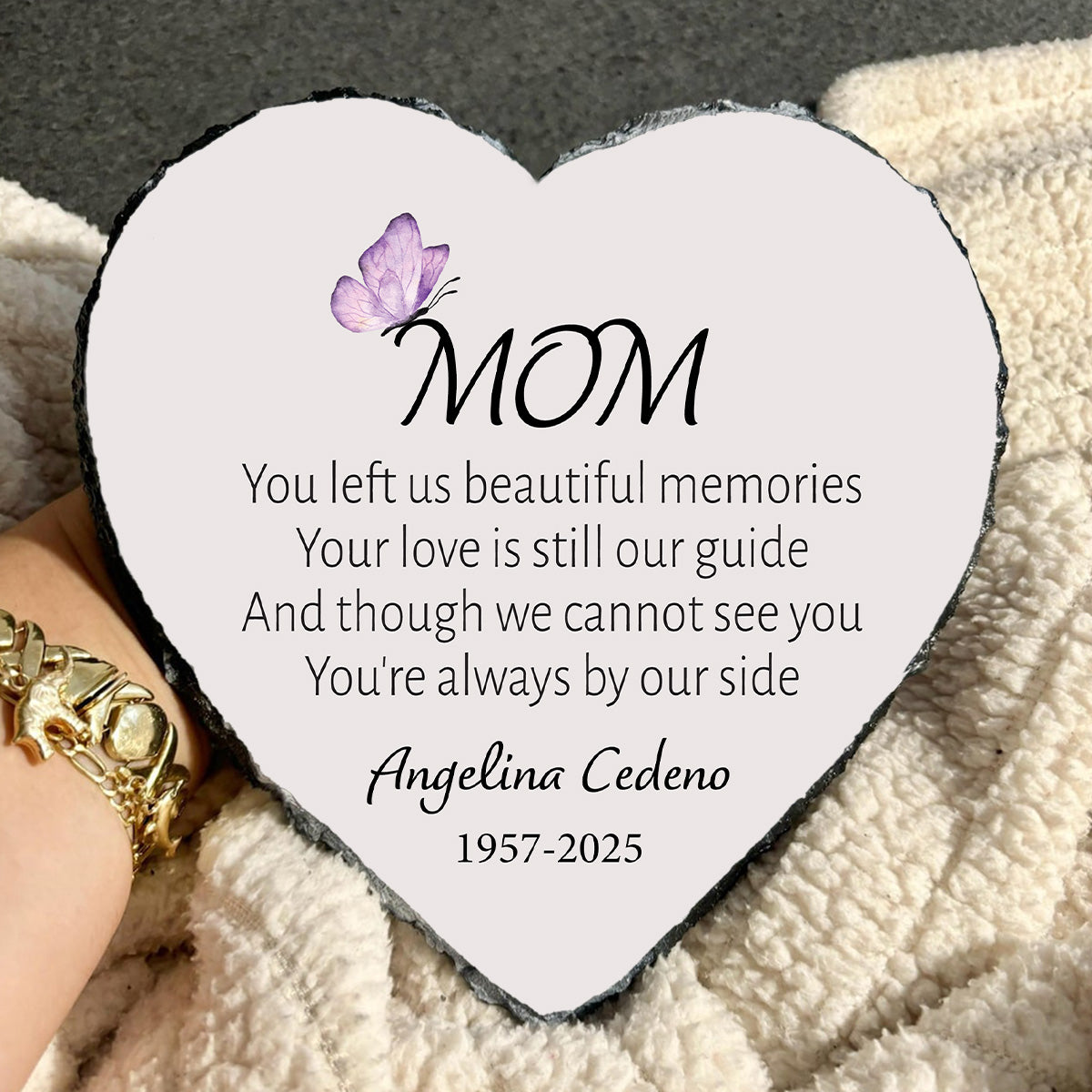 Heart-shaped plaque with a message to 'Mom' on a textured surface.