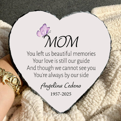 Heart-shaped plaque with a message to 'Mom' on a textured surface.