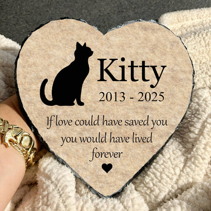 Heart-shaped plaque with a cat silhouette and text on a textured surface