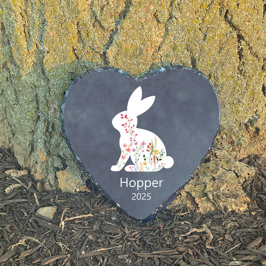 Personalized rabbit memorial garden stone at sunlit tree base. Customized with name Hopper. Sympathy gift for loss of bunny.